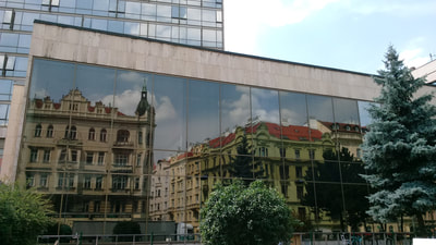 Photo of buildings reflection on a building