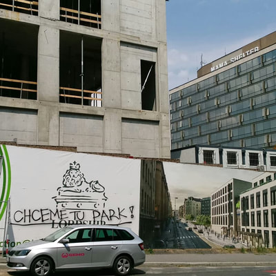 photo of graffiti message on a billboard for a development